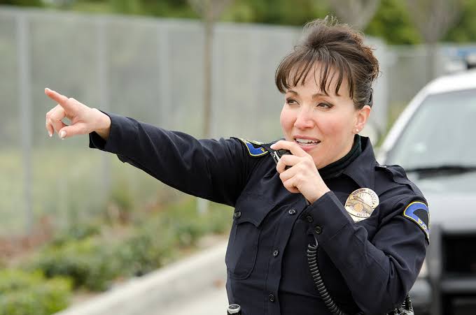 Patrol officer using a two-way radio to coordinate a dispatched response