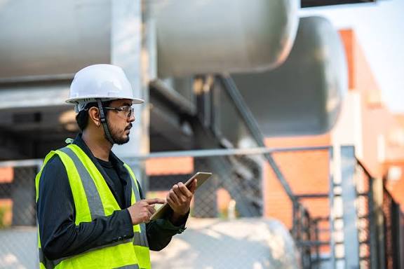 Field inspector recording test results on a tablet at a commercial site