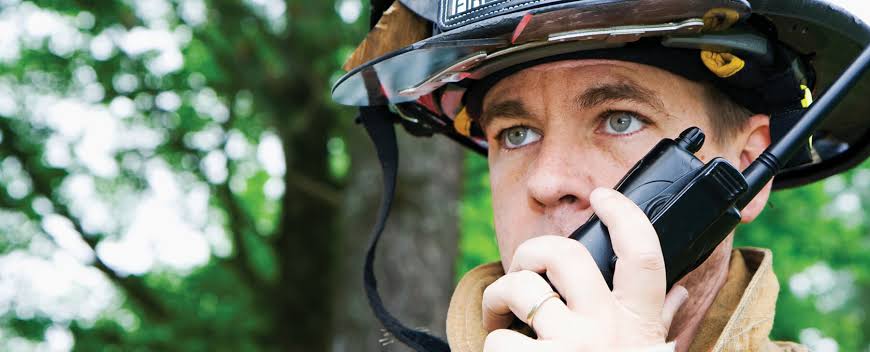 Firefighter using a two-way radio inside a building